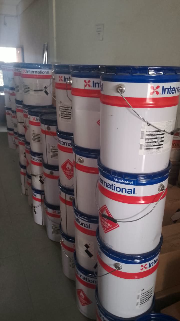 Stacked International Paint pails in stock at the Yunara office in Batam
